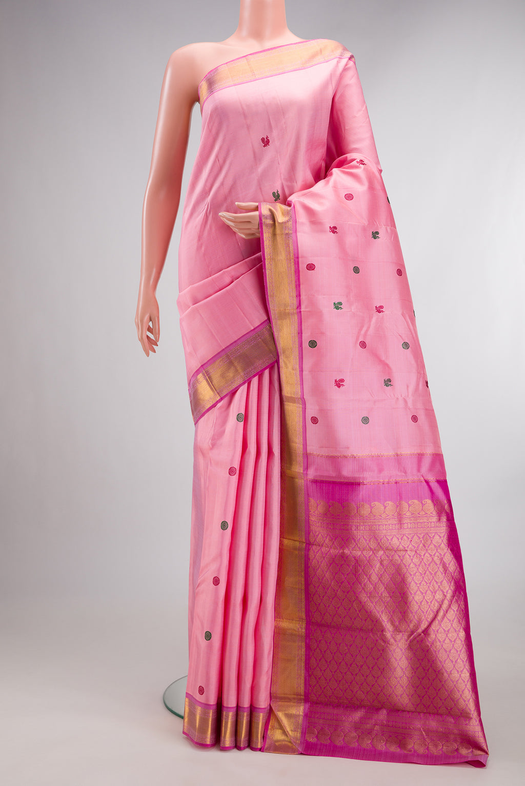 Pure Silk Rose pink Kanjivaram Saree with Thread Butta on the body and Zari Border.  displayed on a mannequin
