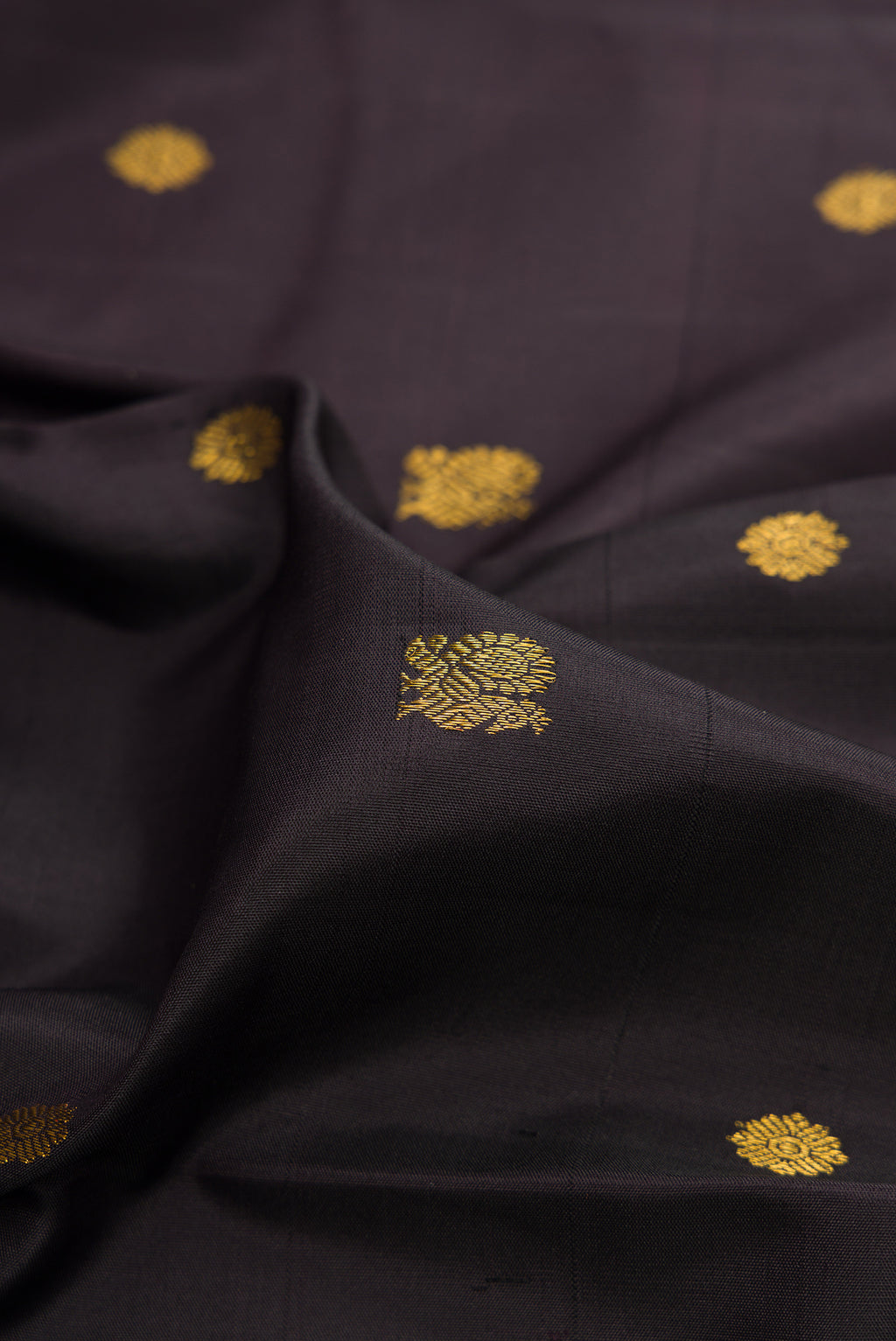 Close up of Pure Silk Coffee Brown Kanjivaram Saree with Zari Butta on the body and Ganga Jamuna Border.  displaying folds