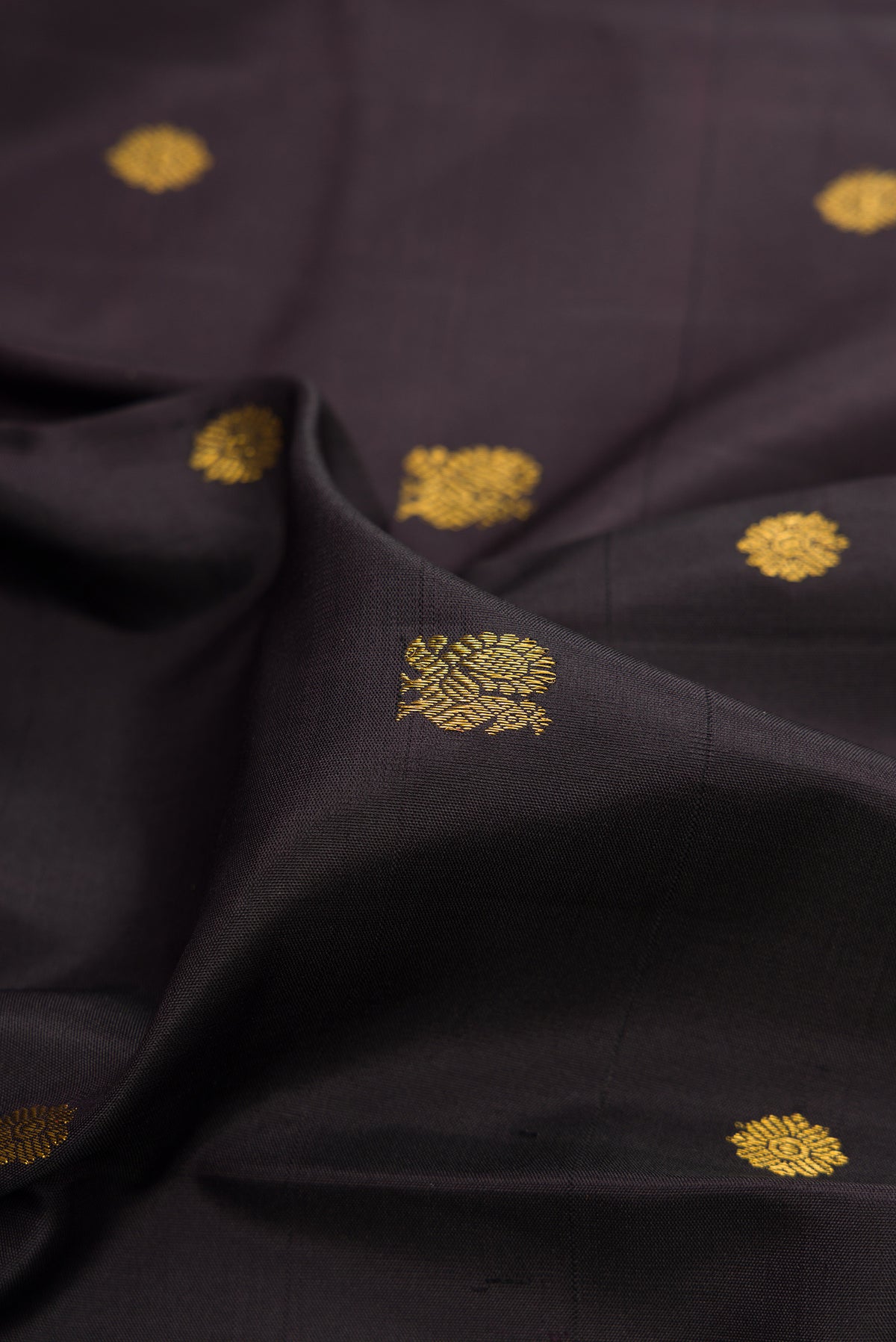 Close up of Pure Silk Coffee Brown Kanjivaram Saree with Zari Butta on the body and Ganga Jamuna Border.  displaying folds