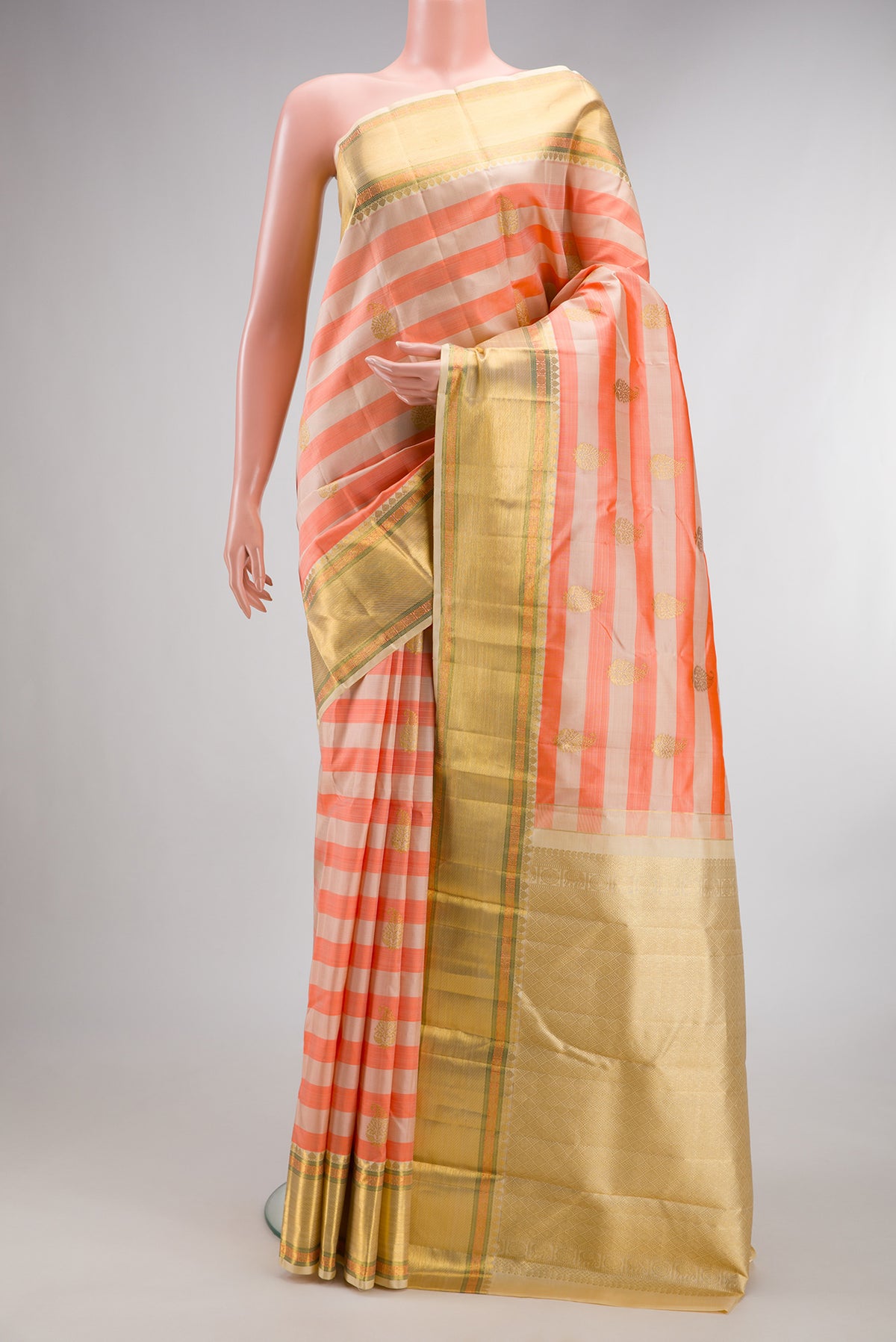 Pure Silk Beige and Peach Color Kanjivaram Saree with Stripes on the body and Zari Border.  displayed on a mannequin