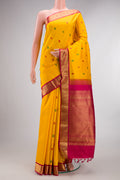 Pure Silk Mustard Kanjivaram Saree with Thread Butta on the body and Zari Border.  displayed on a mannequin