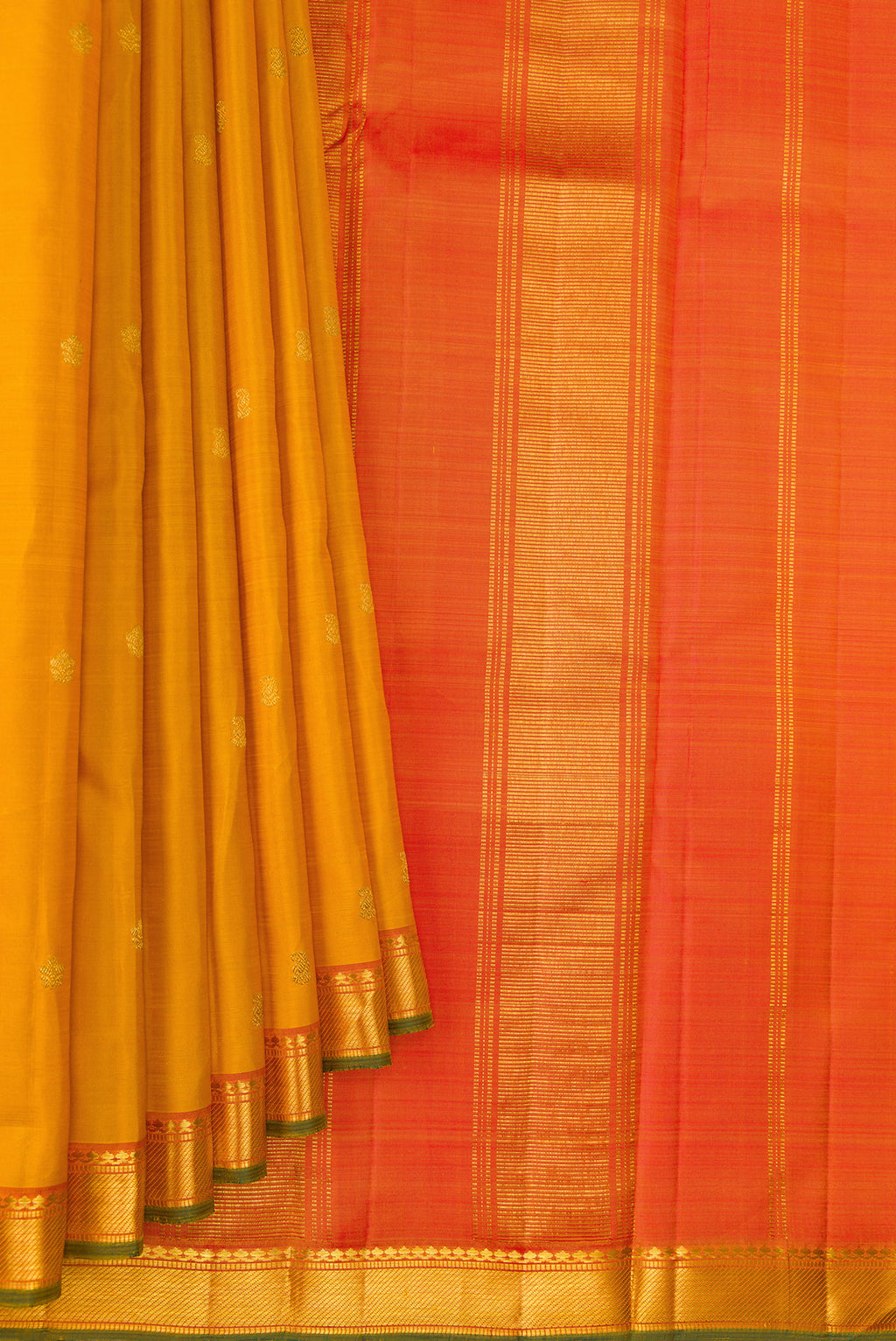 Pleats and pallu of Pure Silk Mustard Kanchipuram Saree with Zari Butta on the body and Zari Border. 
