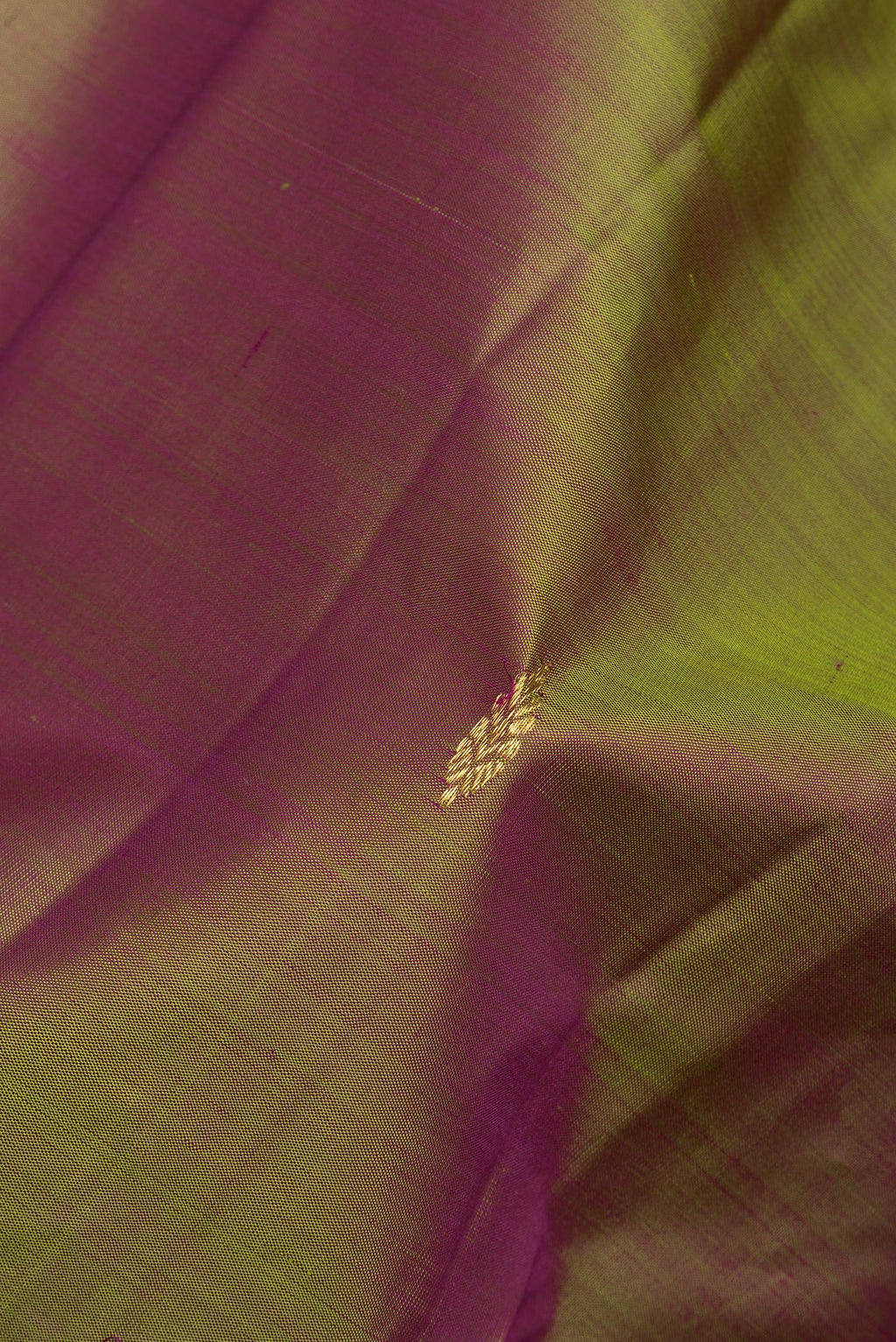 Close up of Pure Silk Mehandi Green Dual Tone Kanchipuram Saree with Zari Butta on the body and Zari Border.  displaying folds