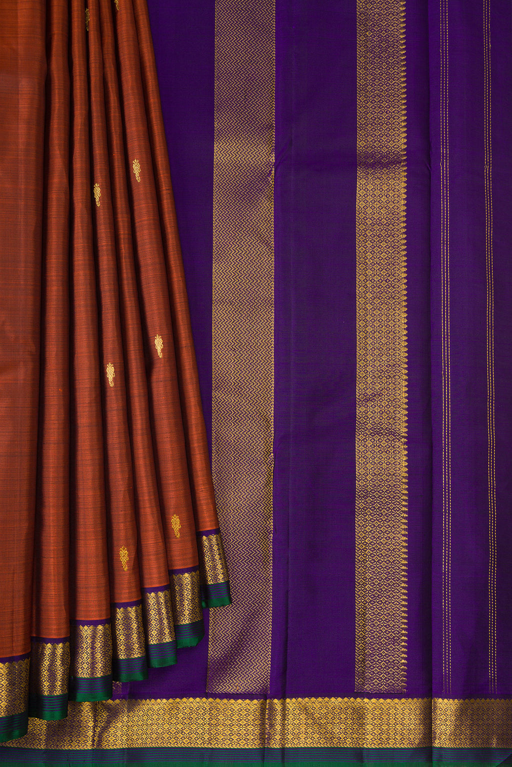 Pleats and pallu of Pure Silk Rust Kanchipuram Saree with Zari Butta on the body and Zari Border. 