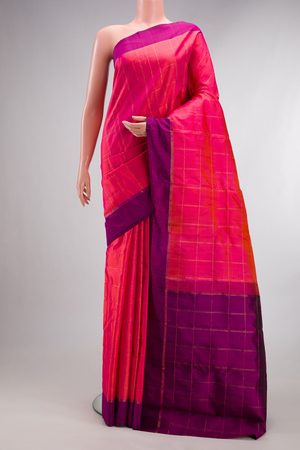 Pure Silk Coral Kanchipuram Saree with Checked design on the body and Plain Border.  displayed on a mannequin