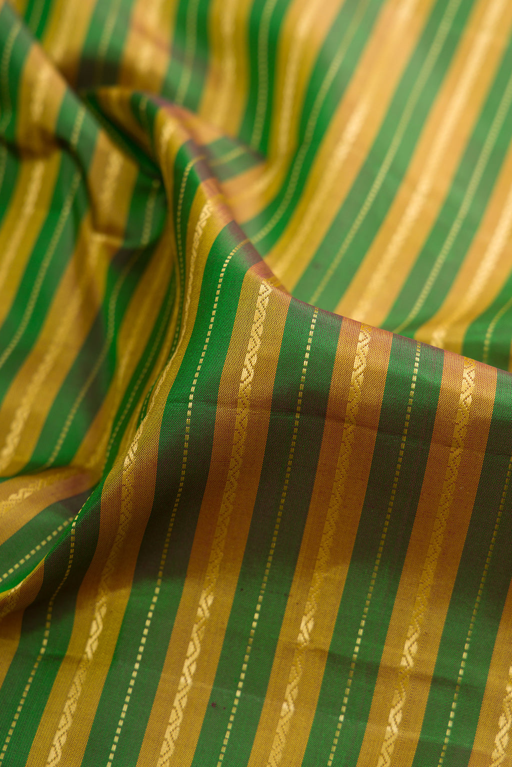 Close up of Pure Silk Green Kanchipuram Saree with Stripes on the body and Zari Border.  displaying folds