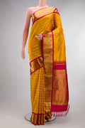 Pure Silk Mustard Kanjivaram Saree with Veldhari on the body and Zari Border.  displayed on a mannequin