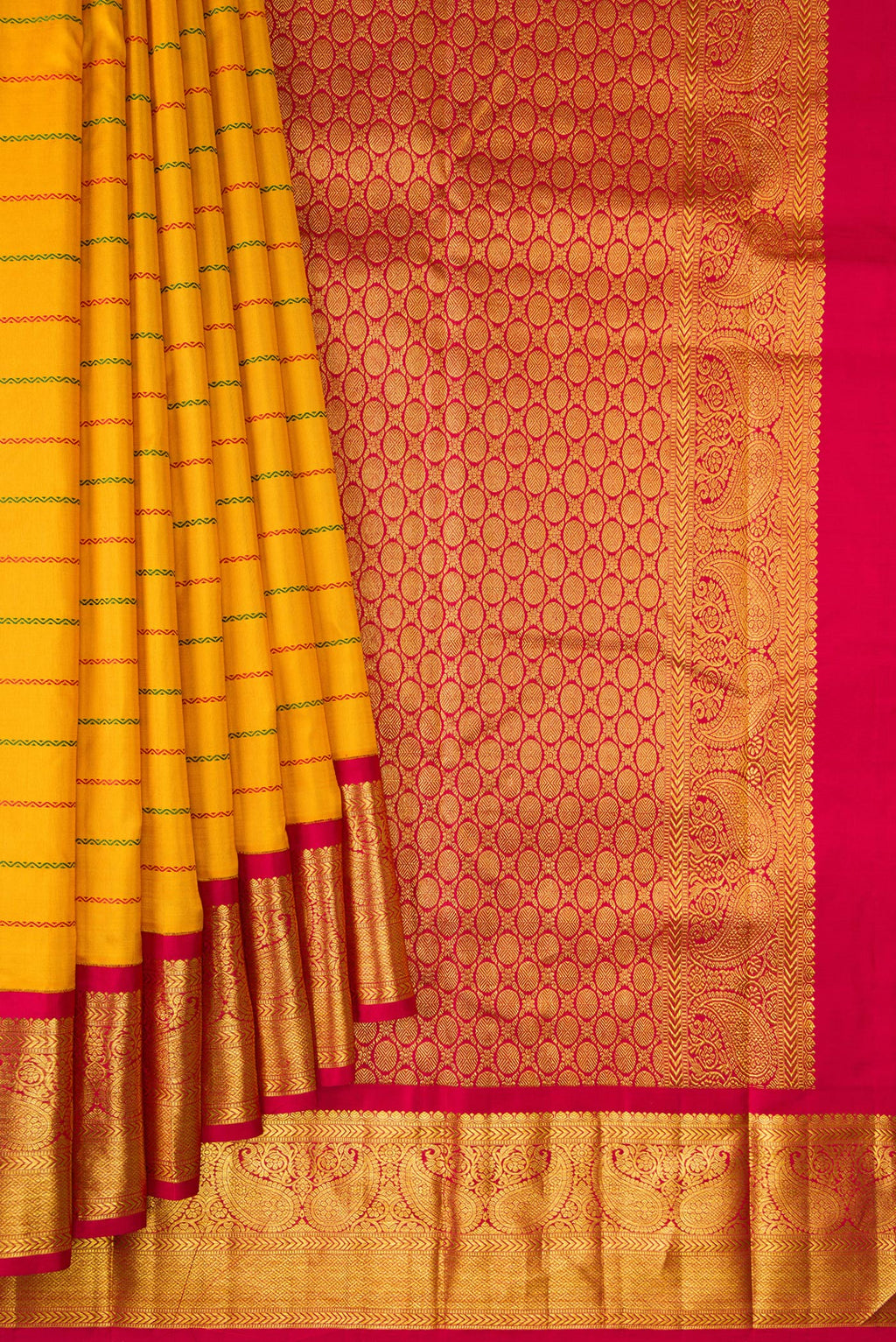 Pleats and pallu of Pure Silk Mustard Kanjivaram Saree with Veldhari on the body and Zari Border. 
