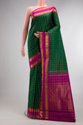 Pure Silk Bottle Green Kanchipuram Saree with Checked design on the body and Zari Border.  displayed on a mannequin