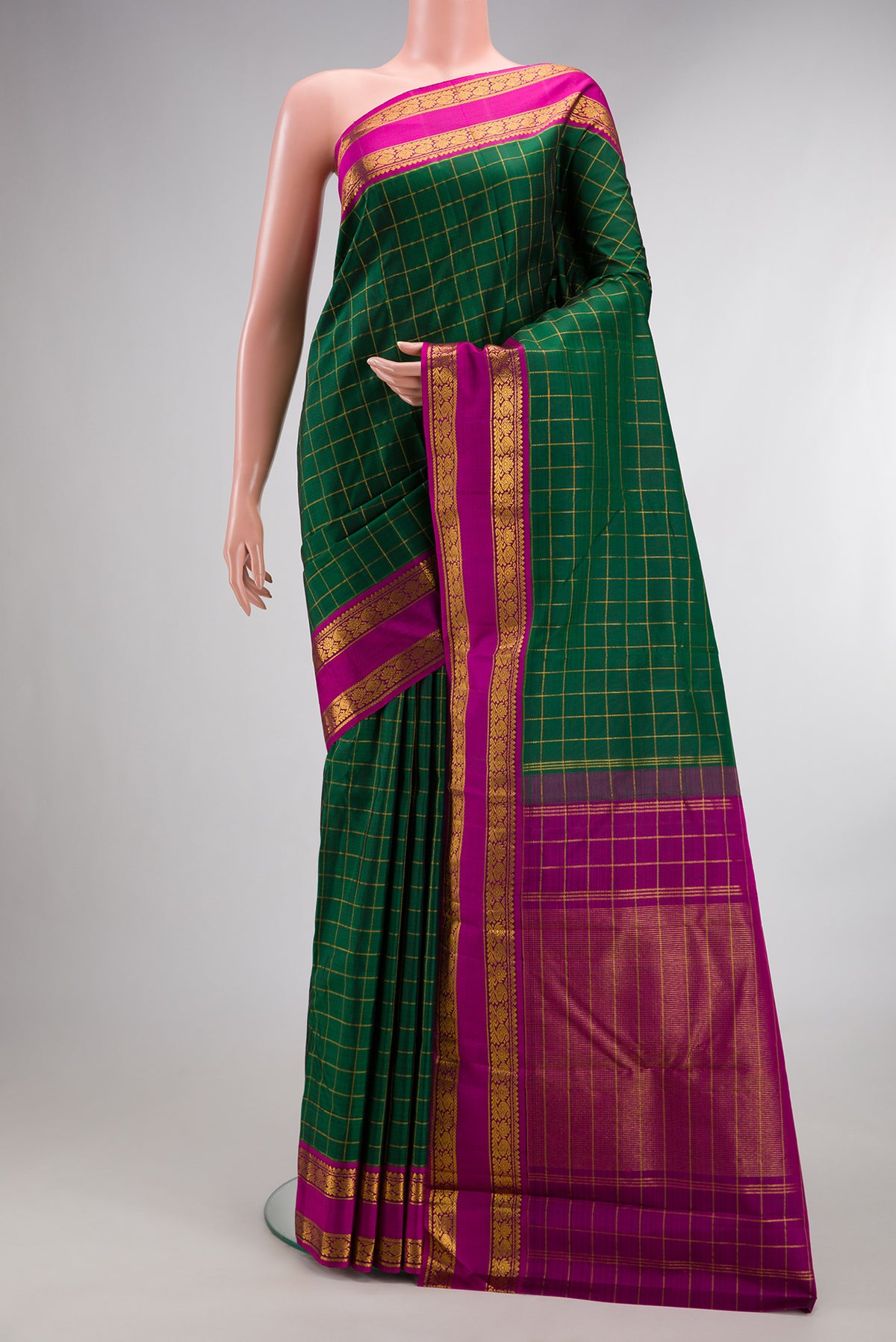 Pure Silk Bottle Green Kanchipuram Saree with Checked design on the body and Zari Border.  displayed on a mannequin