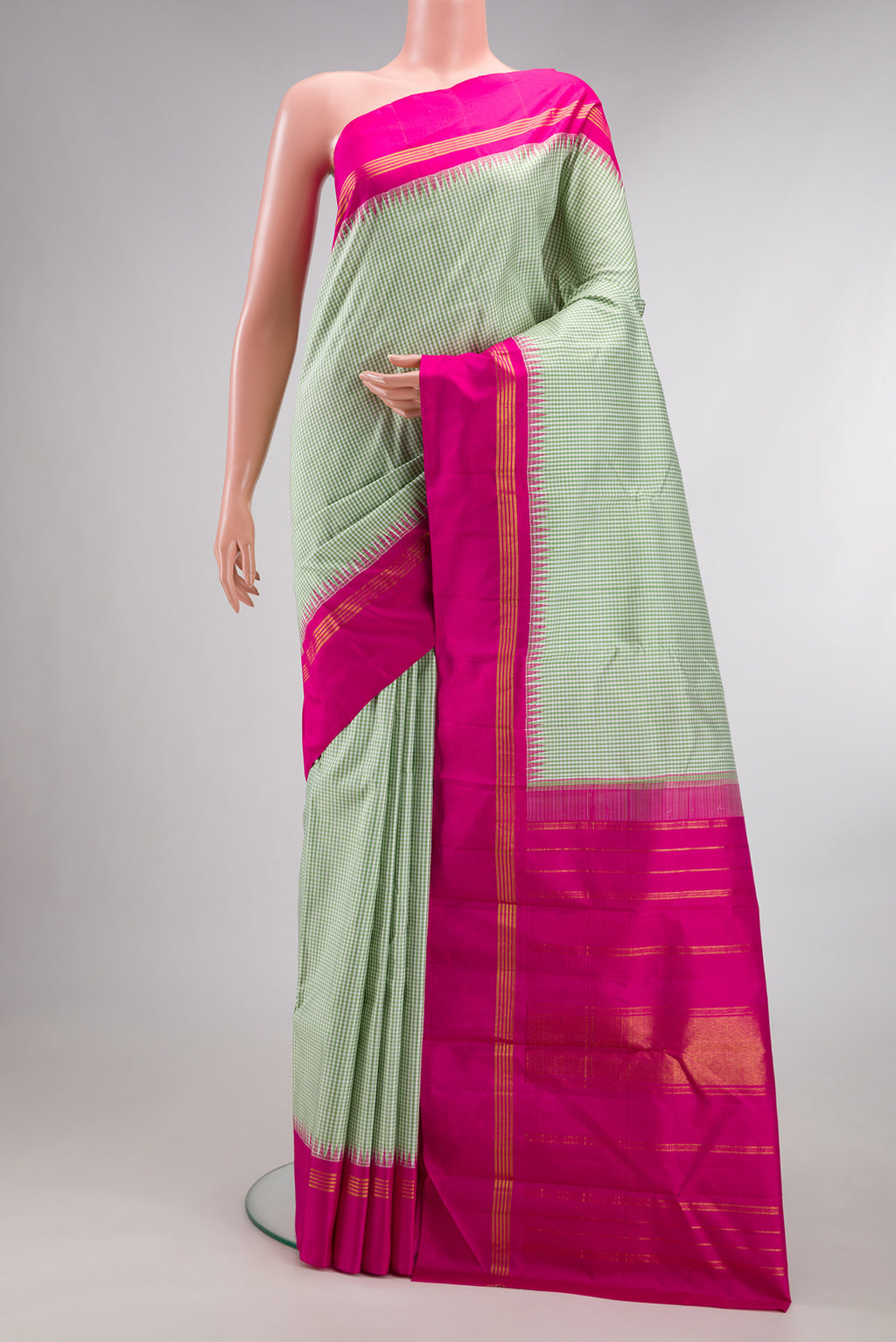 Pure Silk Pista Green Dual Tone Kanjivaram Saree with Checked design on the body and Temple Border.  displayed on a mannequin