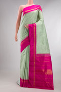 Pure Silk Pista Green Dual Tone Kanjivaram Saree with Checked design on the body and Temple Border.  displayed on a mannequin