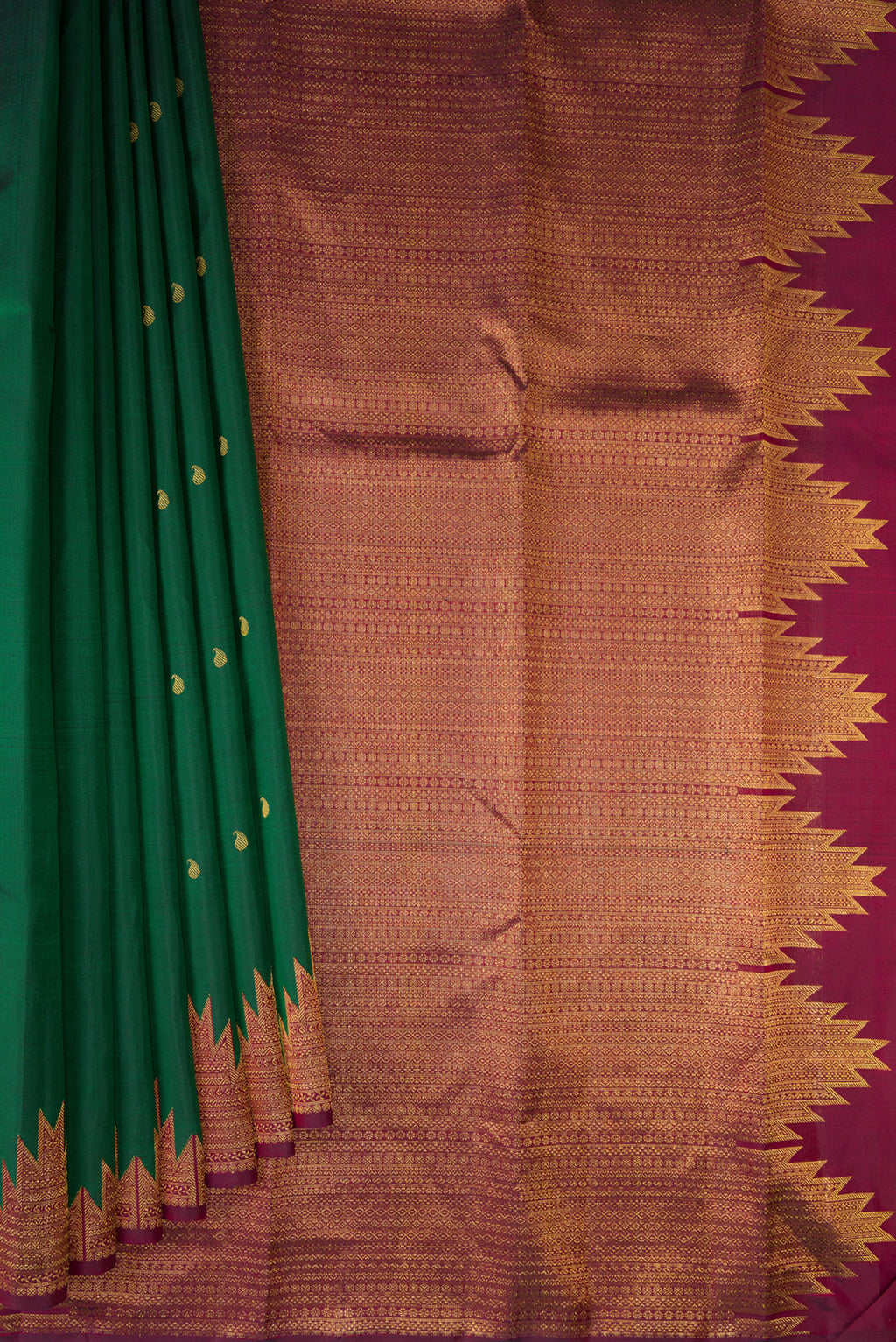 Pleats and pallu of Pure Silk Bottle Green Kanchipuram Saree with Zari Butta on the body and Temple Border. 