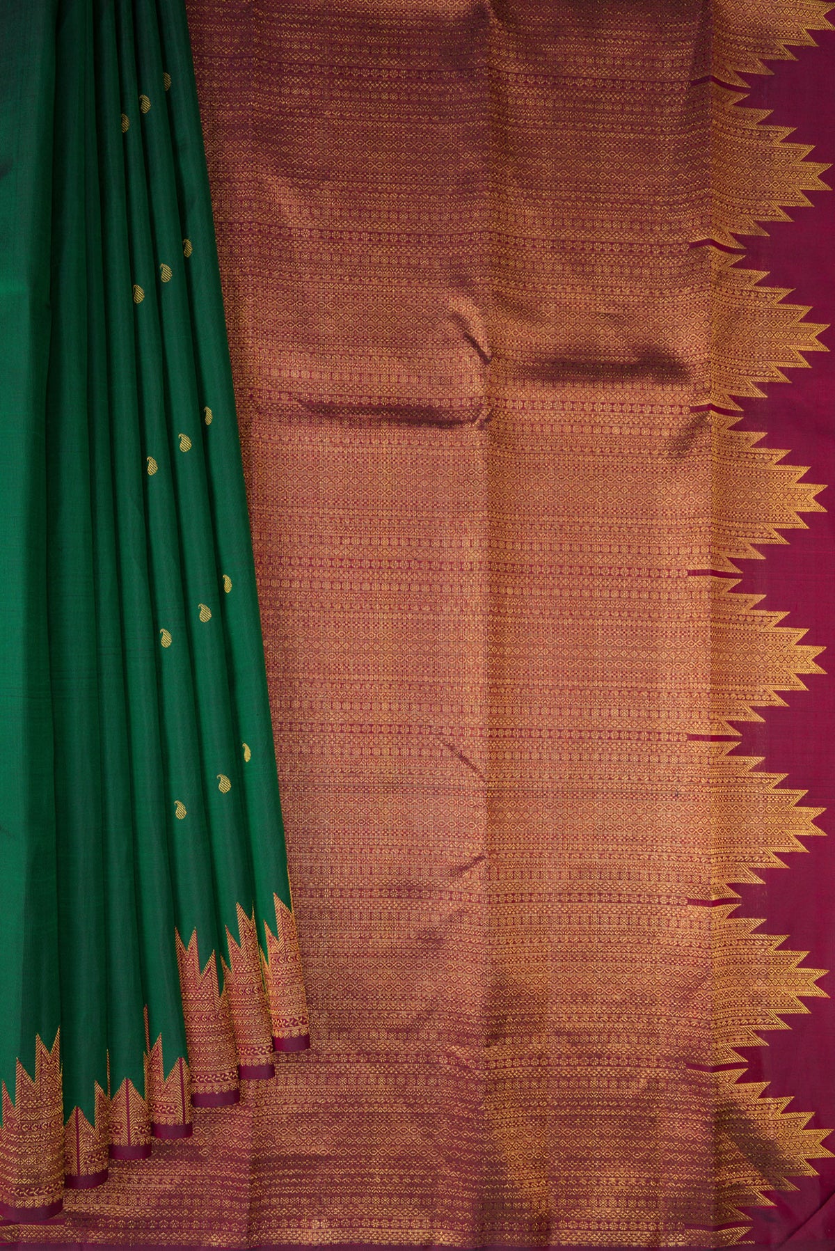 Pleats and pallu of Pure Silk Bottle Green Kanchipuram Saree with Zari Butta on the body and Temple Border. 