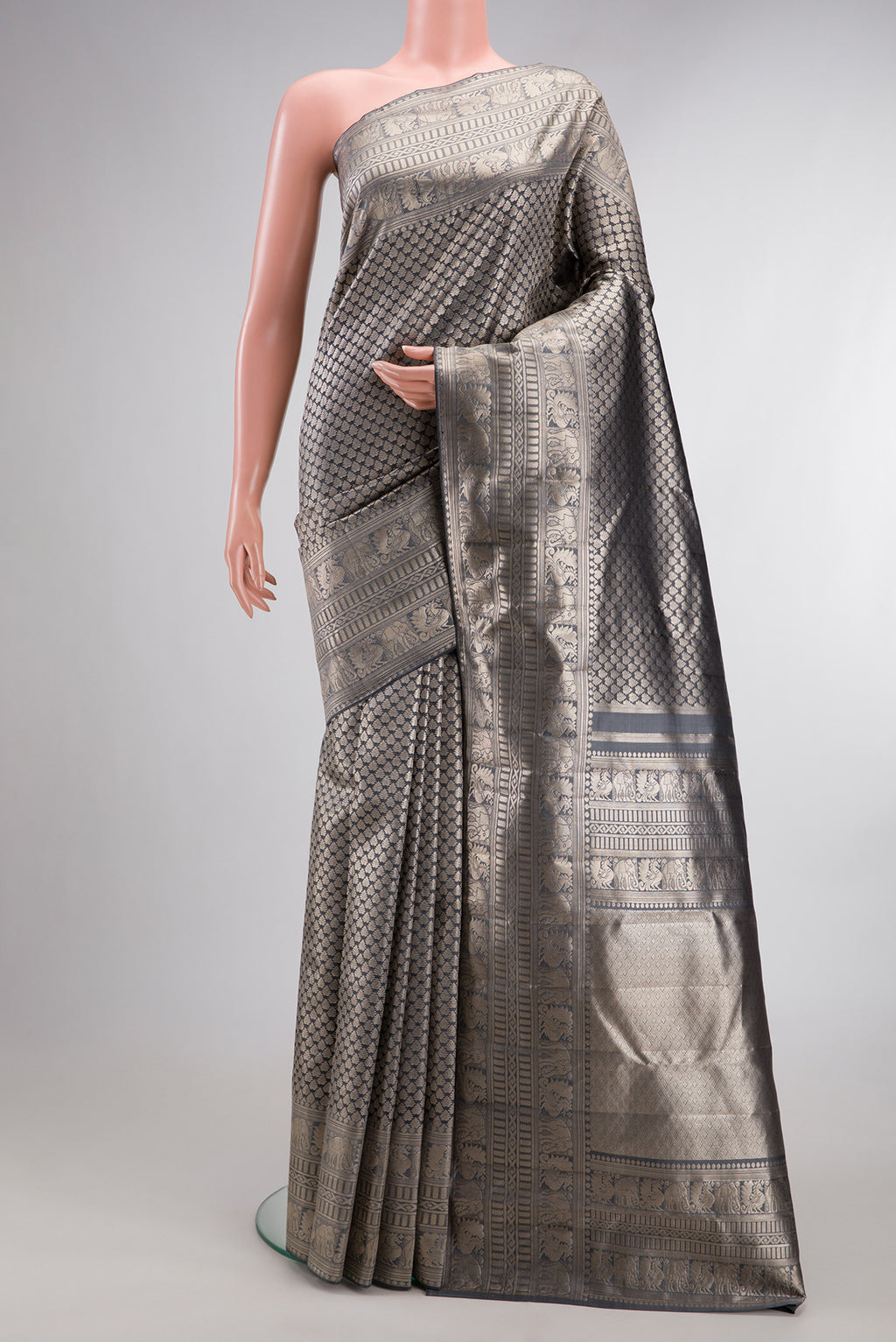 Grey Kanchipuram Tissue Saree with Zari Brocade on the body and Fancy Border.  displayed on a mannequin