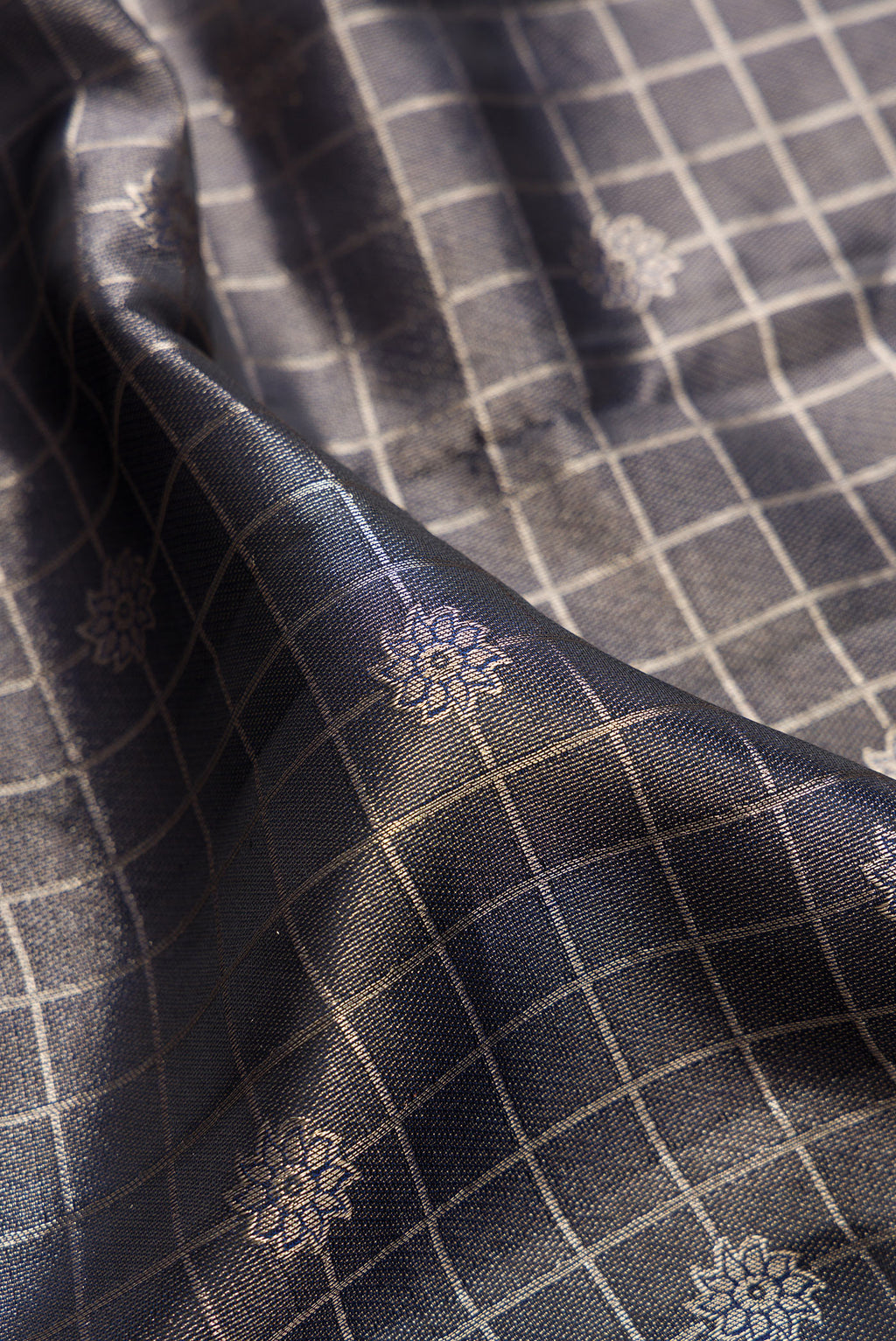Close up of Navy Blue Dual Tone Kanchipuram Tissue Saree with Zari Brocade on the body and Fancy Border.  displaying folds