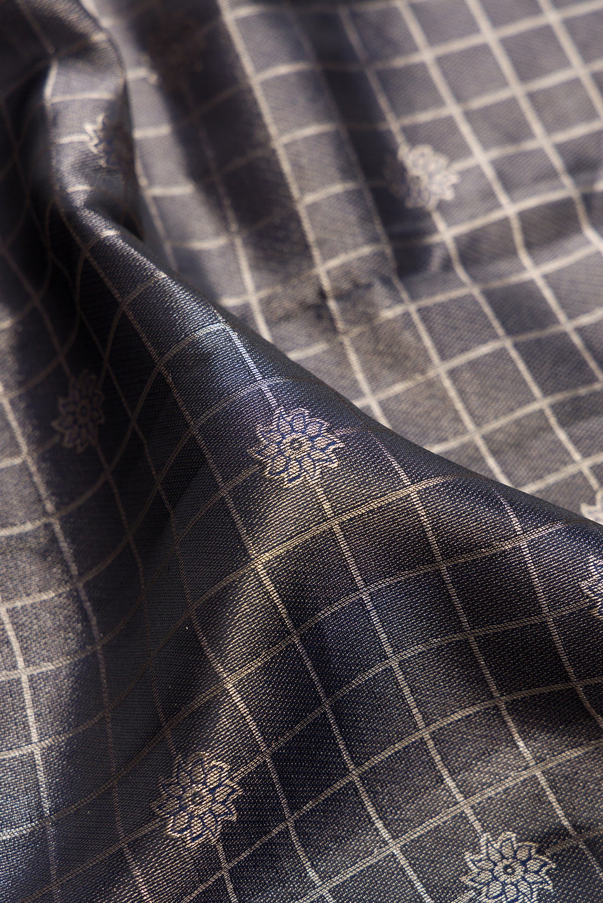 Close up of Navy Blue Dual Tone Kanchipuram Tissue Saree with Zari Brocade on the body and Fancy Border.  displaying folds