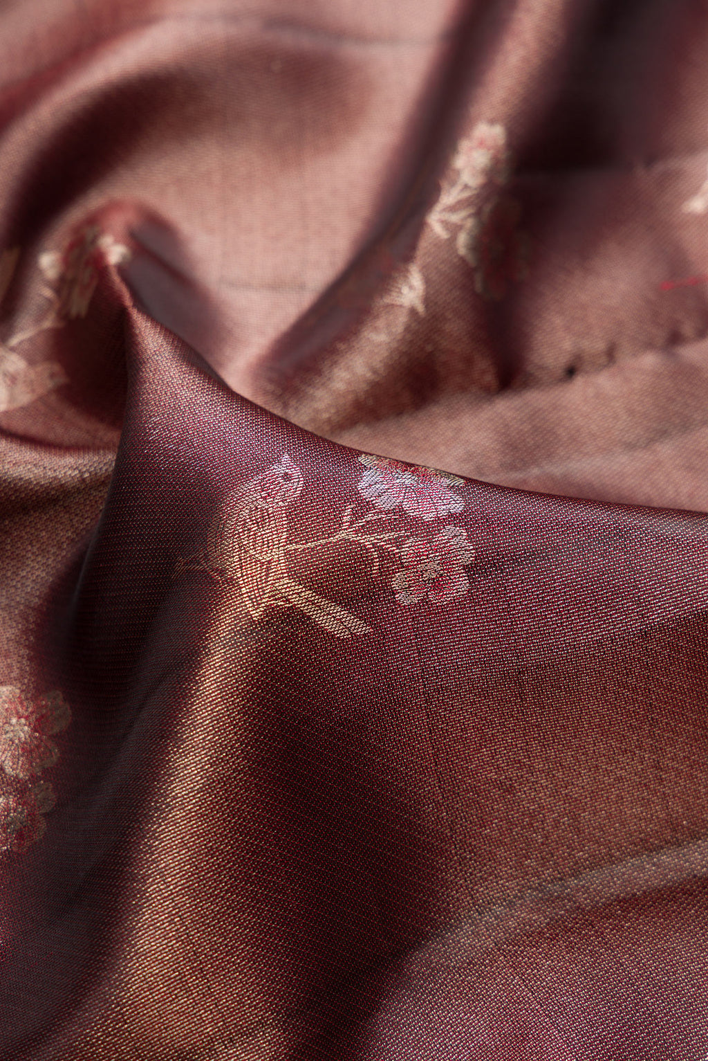 Close up of Maroon Dual Tone Kanchipuram Tissue Saree with Zari Brocade on the body and Fancy Border.  displaying folds