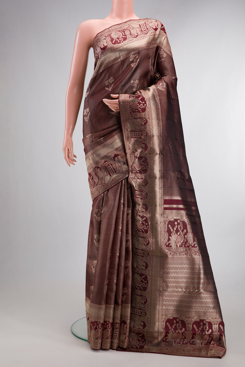 Maroon Dual Tone Kanchipuram Tissue Saree with Zari Brocade on the body and Fancy Border.  displayed on a mannequin