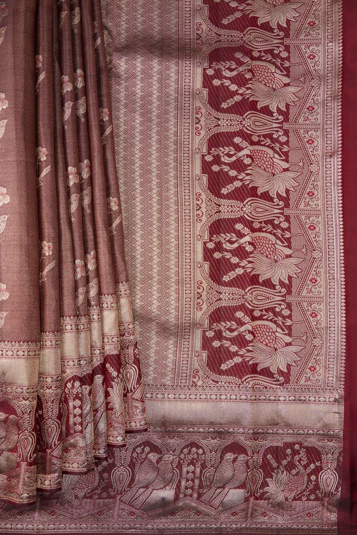 Pleats and pallu of Maroon Dual Tone Kanchipuram Tissue Saree with Zari Brocade on the body and Fancy Border. 