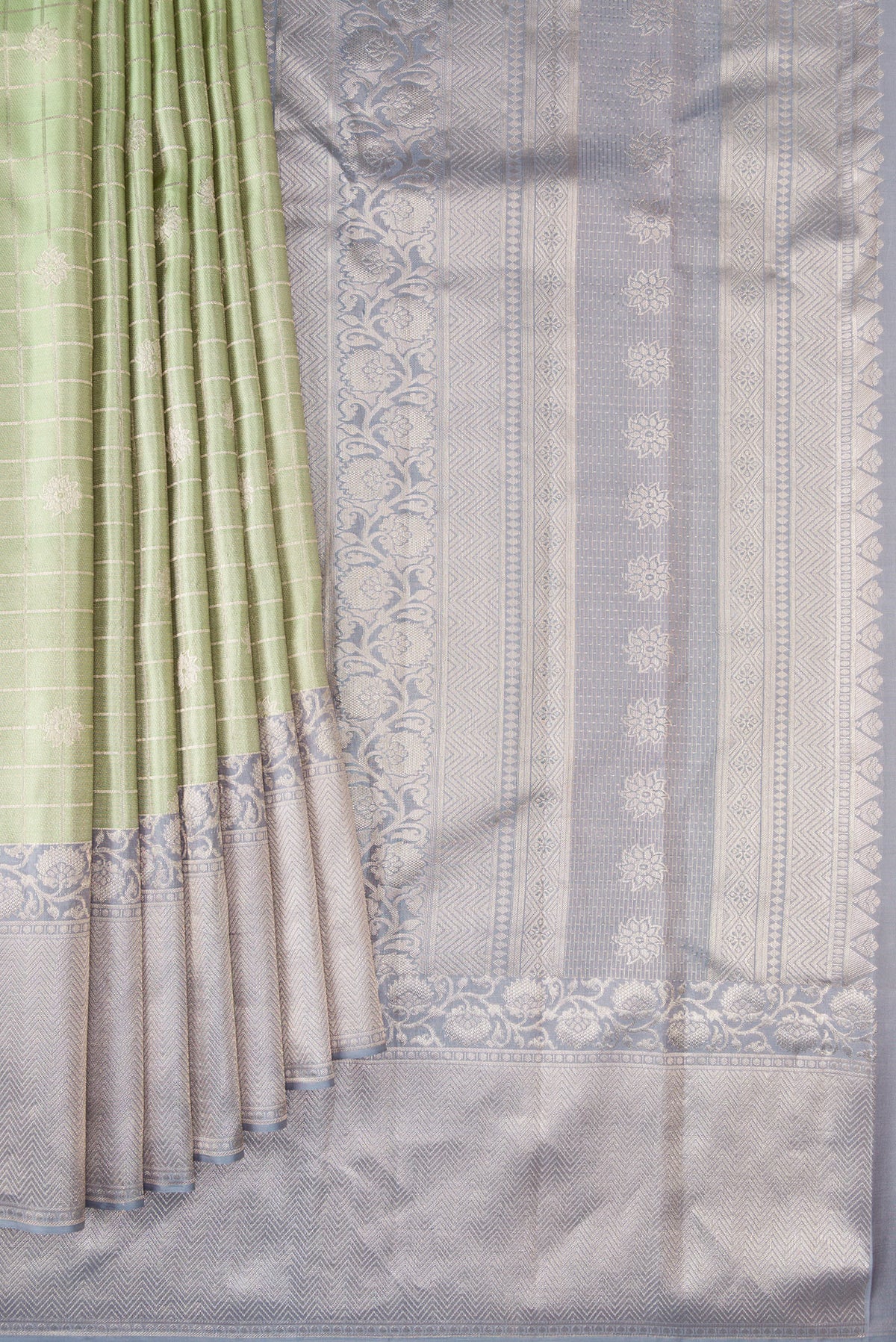Pleats and pallu of Pista Green Kanchipuram Tissue Saree with Checked design on the body and Fancy Border. 