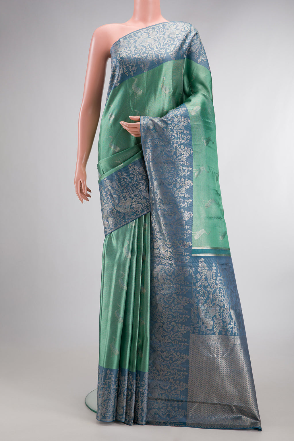 Sea Green Dual Tone Kanchipuram Tissue Saree with Zari Brocade on the body and Fancy Border.  displayed on a mannequin