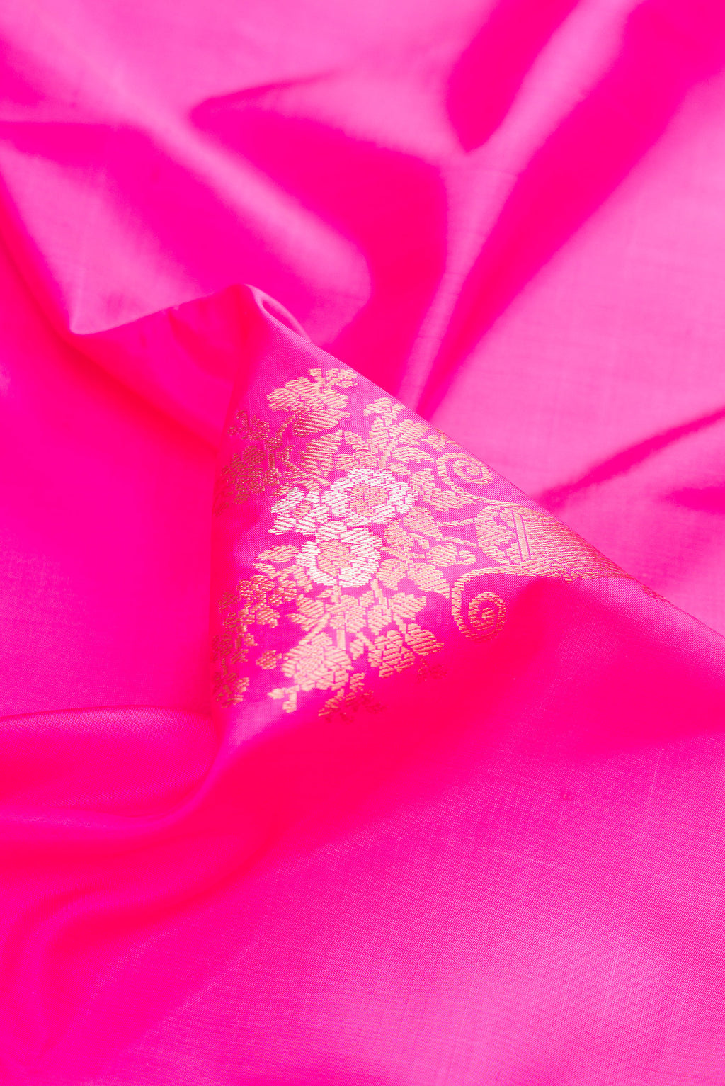 Close up of Pure Silk Pink Banarasi Saree with Zari Butta on the body and Zari Border.  displaying folds