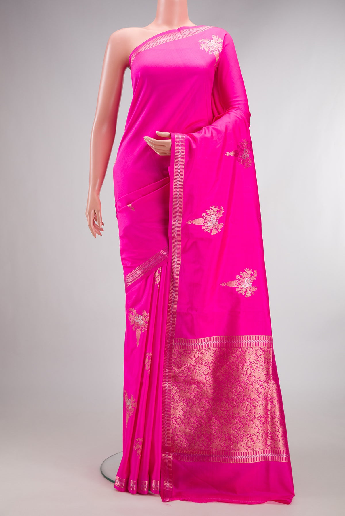 Pure Silk Pink Banarasi Saree with Zari Butta on the body and Zari Border.  displayed on a mannequin