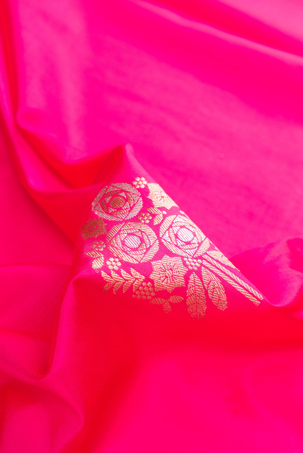 Close up of Pure Silk Pink Banarasi Saree with Zari Butta on the body and Zari Border.  displaying folds