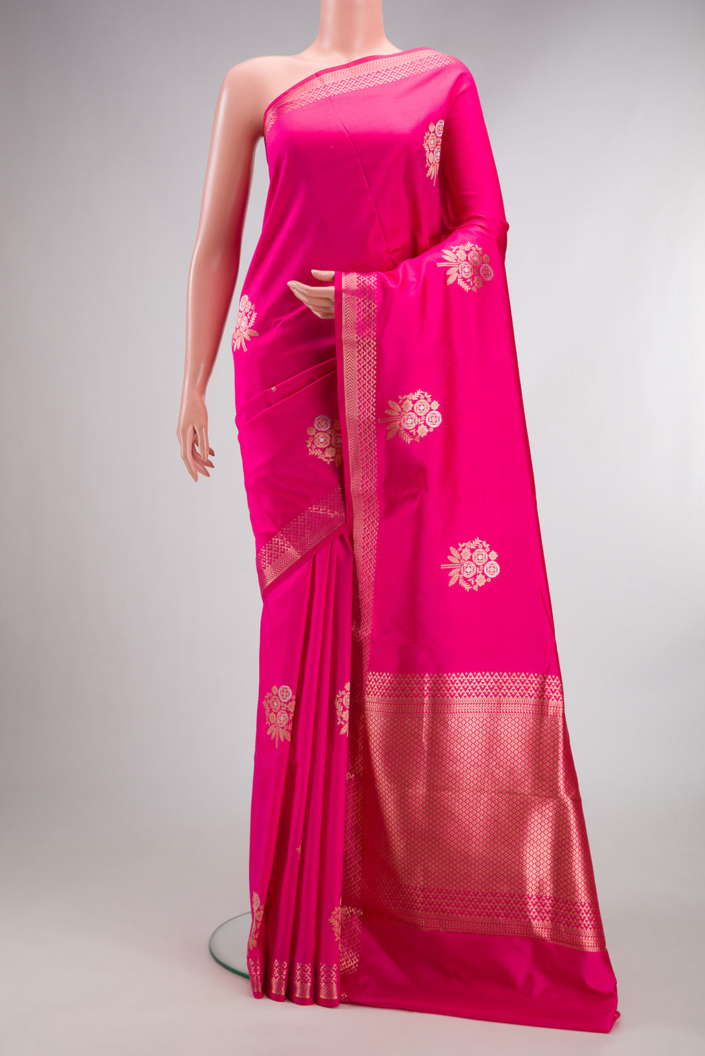 Pure Silk Pink Banarasi Saree with Zari Butta on the body and Zari Border.  displayed on a mannequin