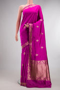 Pure Silk Rani Pink Banarasi Saree with Zari Butta on the body and Zari Border.  displayed on a mannequin