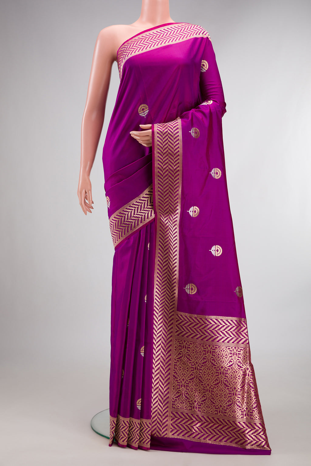 Pure Silk Magenta Banarasi Saree with Zari Butta on the body and Zari Border.  displayed on a mannequin