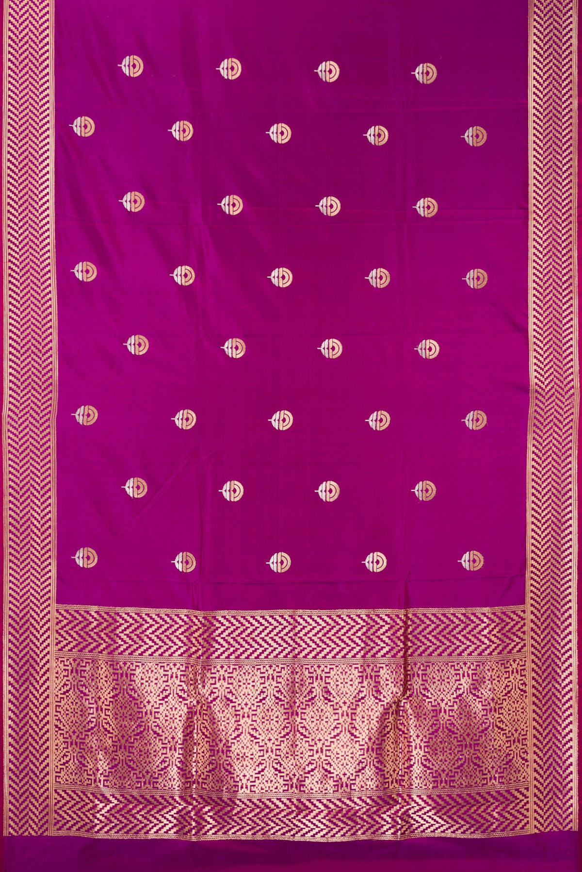 Flat view of Pure Silk Magenta Banarasi Saree with Zari Butta on the body and Zari Border. 