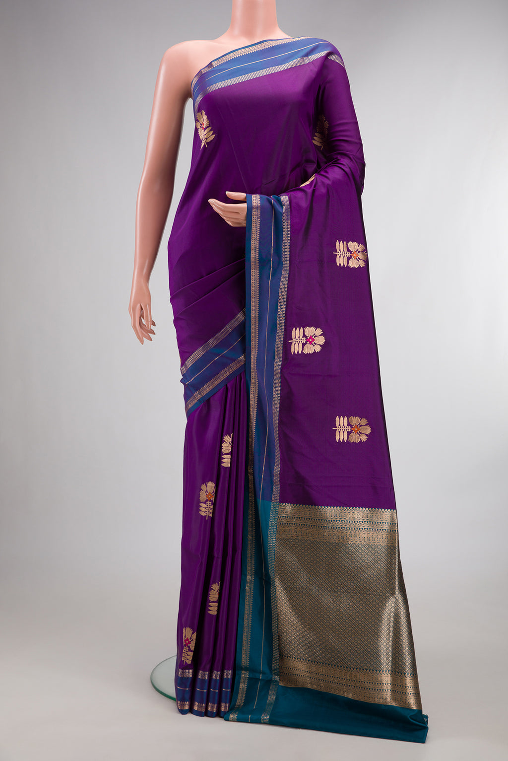 Pure Silk Violet Banarasi Saree with Zari And Thread Butta on the body and Zari Border.  displayed on a mannequin