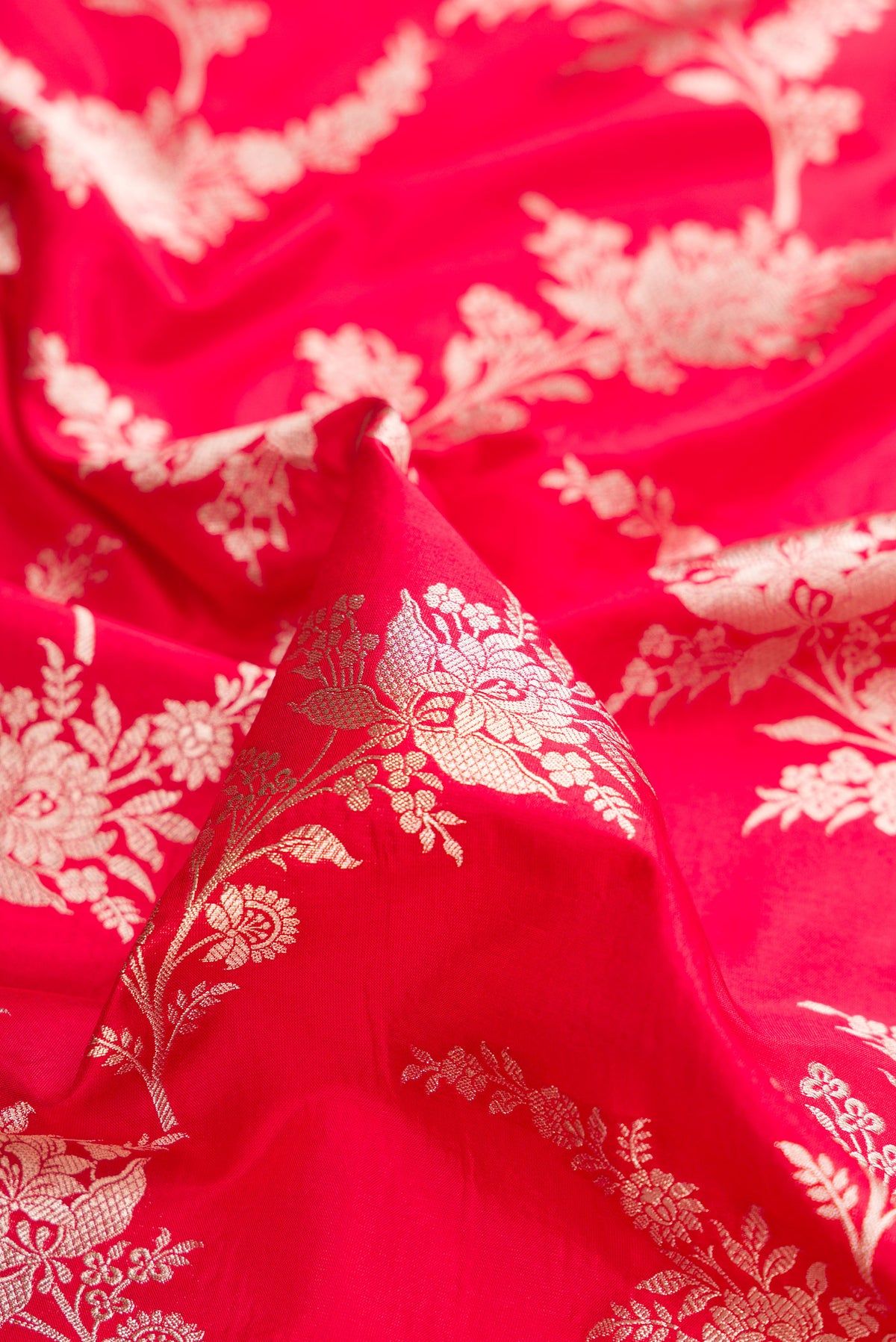 Close up of Pure Silk Red Dual Tone Banarasi Saree with Zari Brocade on the body and Zari Border.  displaying folds