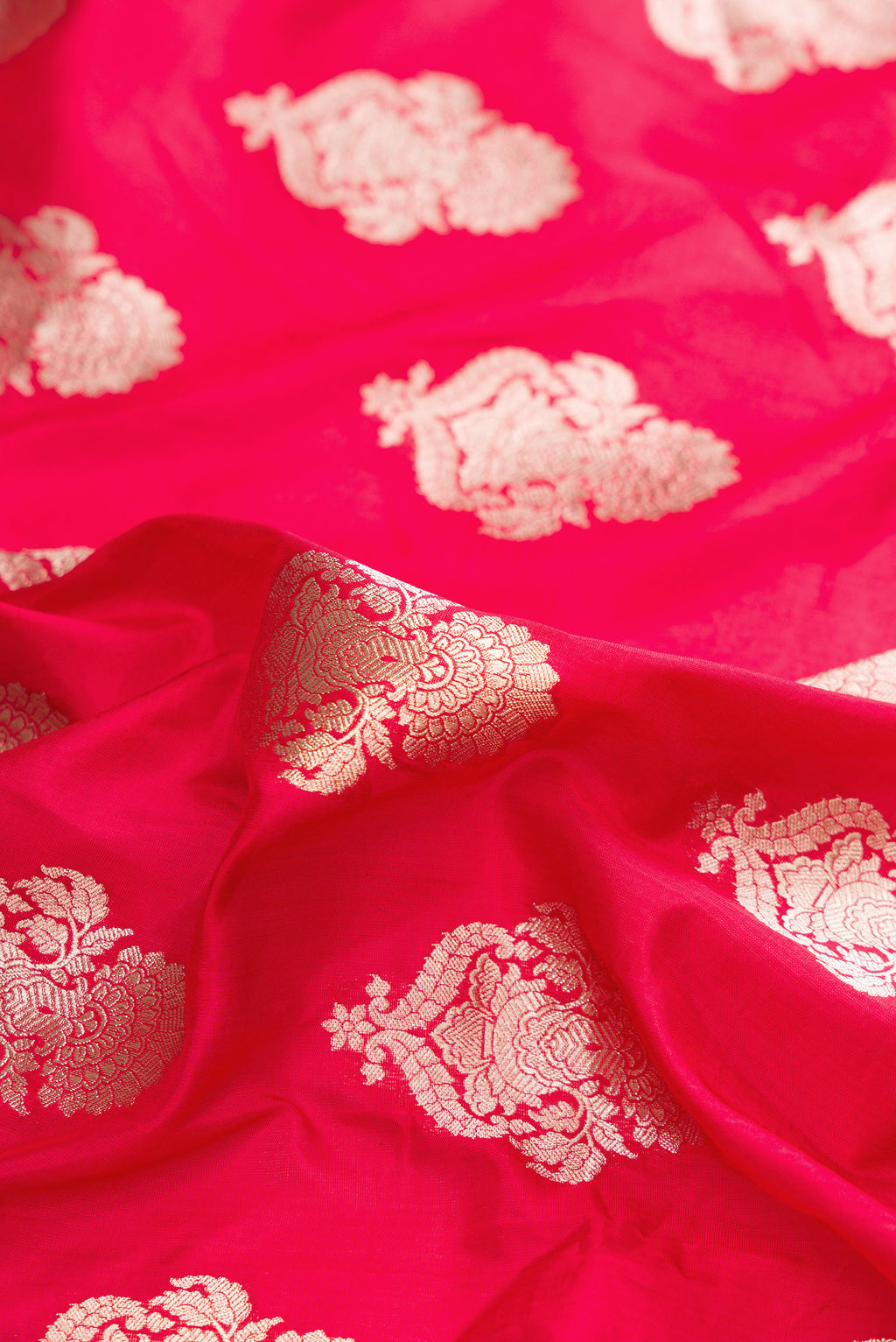 Close up of Pure Silk Red Banarasi Saree with Zari Butta on the body and Zari Border.  displaying folds