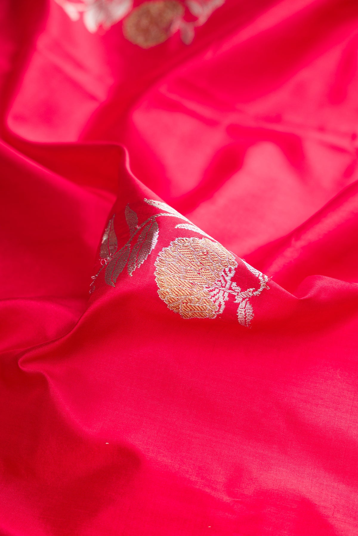 Close up of Pure Silk Red Dual Tone Banarasi Saree with Zari Butta on the body and Zari Border.  displaying folds