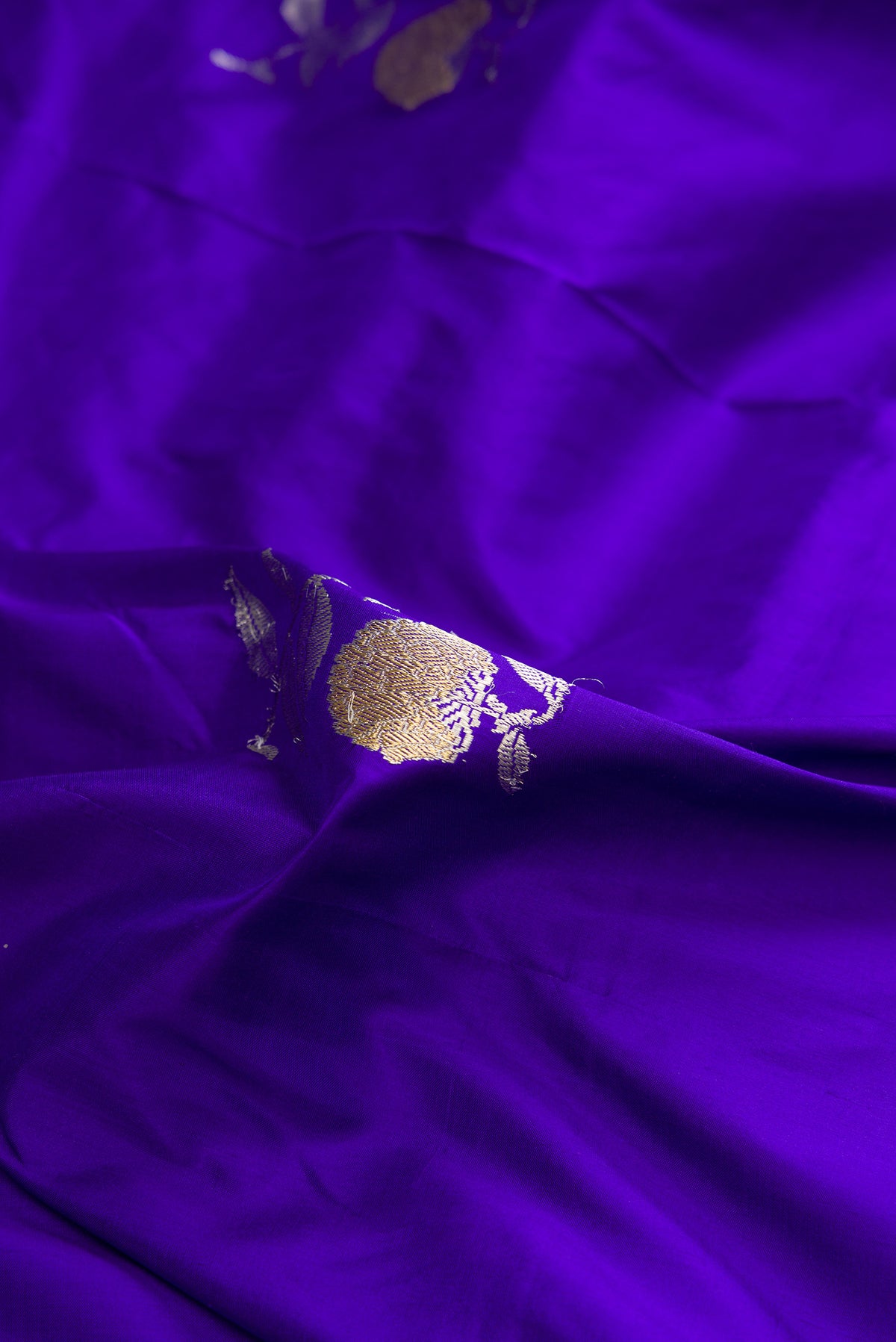 Close up of Pure Silk Royal Blue Banarasi Saree with Zari Butta on the body and Zari Border.  displaying folds