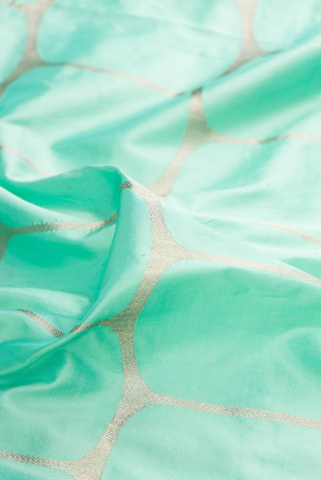 Close up of Pure Silk Sea Green Banarasi Saree with Zari Brocade on the body and Zari Border.  displaying folds