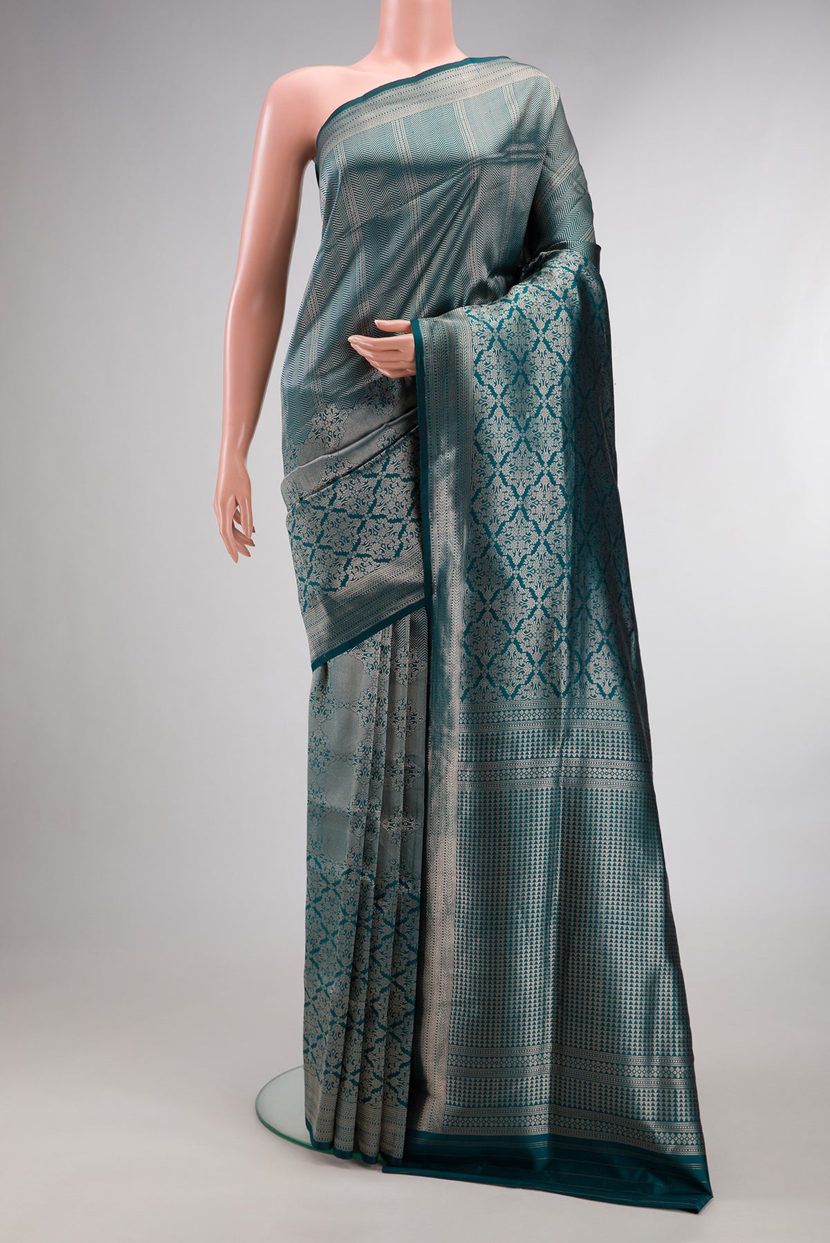 Pure Silk Peacock Blue Banarasi Saree with Zari Butta on the body and Zari Border.  displayed on a mannequin