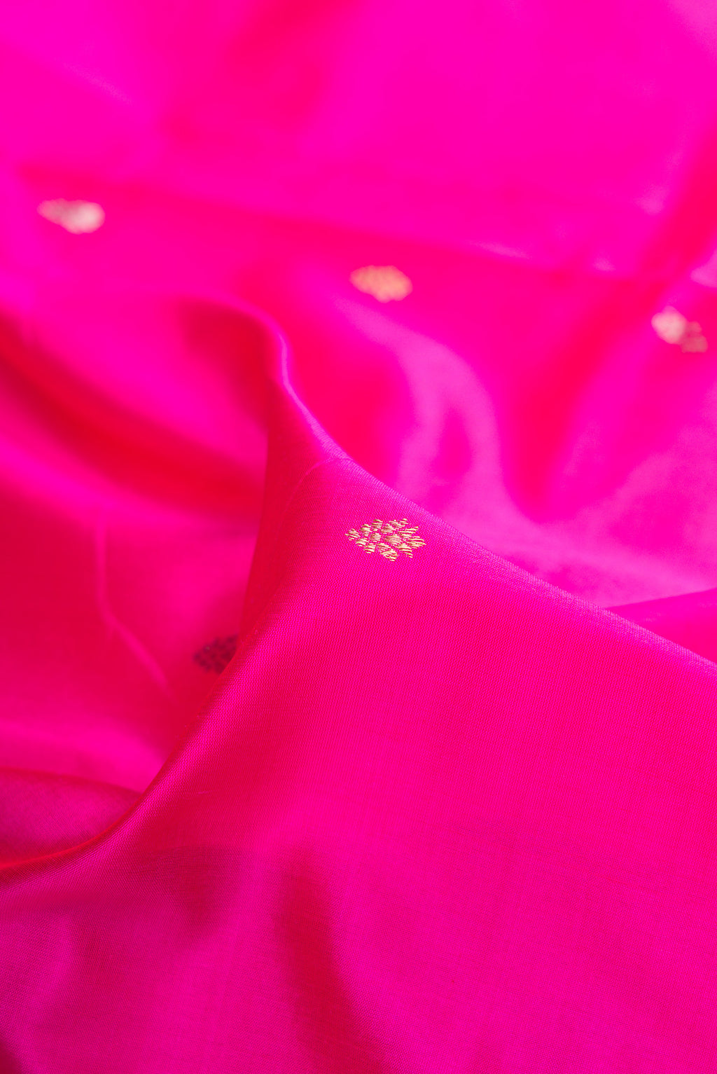 Close up of Pure Silk Dark Pink Banarasi Saree with Zari Butta on the body and Fancy Border.  displaying folds