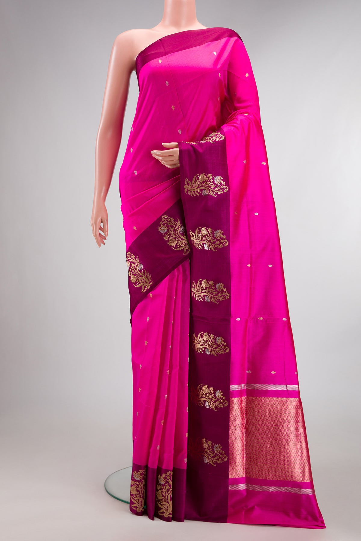 Pure Silk Dark Pink Banarasi Saree with Zari Butta on the body and Fancy Border.  displayed on a mannequin