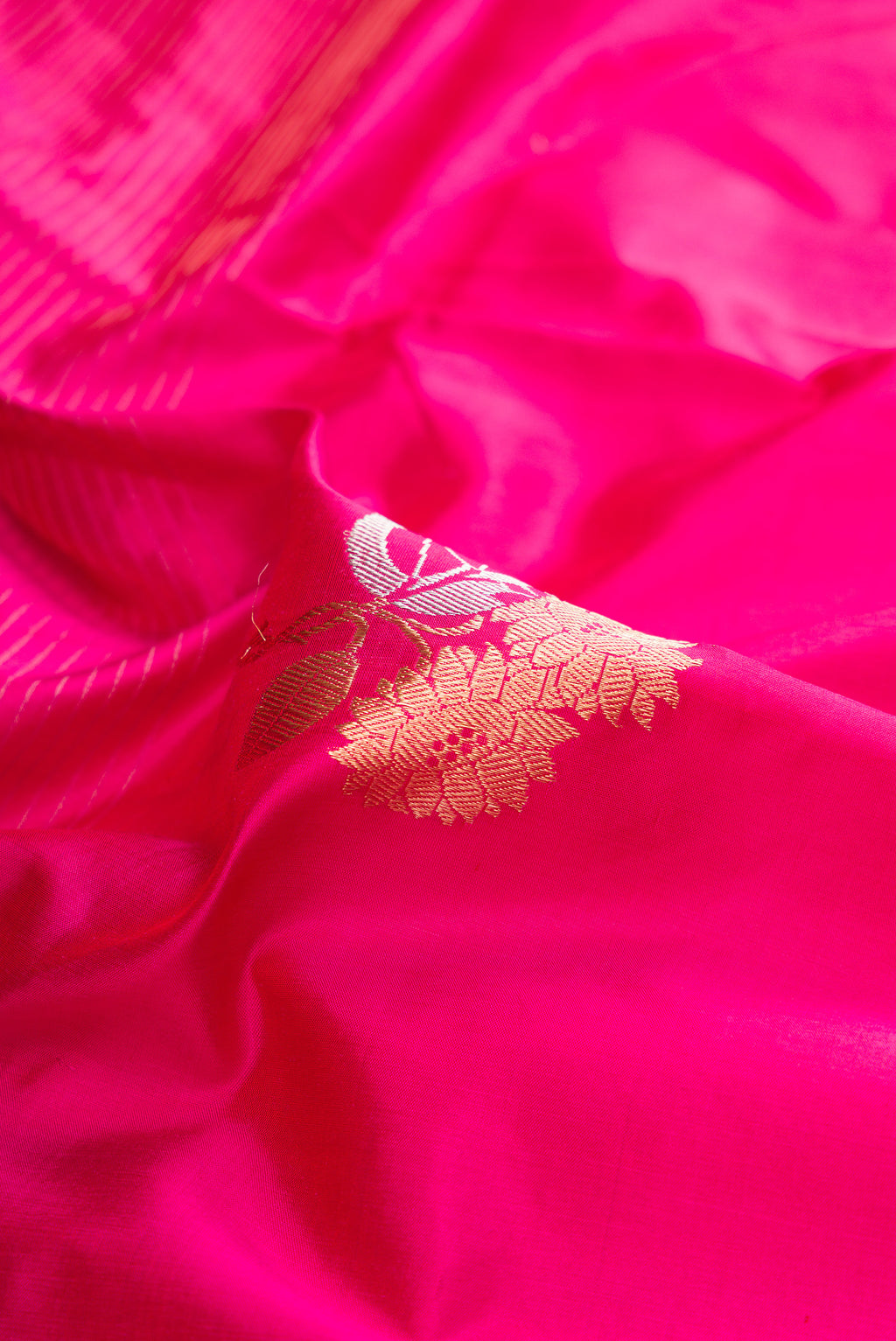 Close up of Pure Silk Dark Pink Dual Tone Banarasi Saree with Zari Butta on the body and Fancy Border.  displaying folds