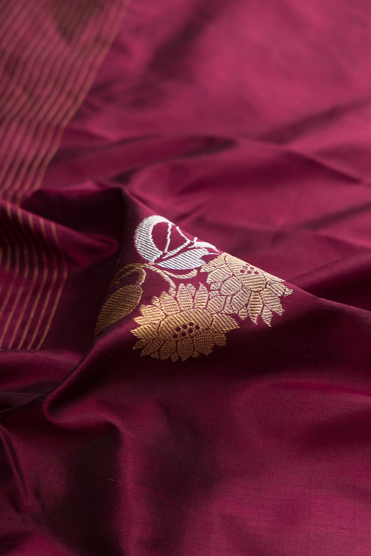 Close up of Pure Silk Coffee Brown Dual Tone Banarasi Saree with Zari Butta on the body and Zari Border.  displaying folds