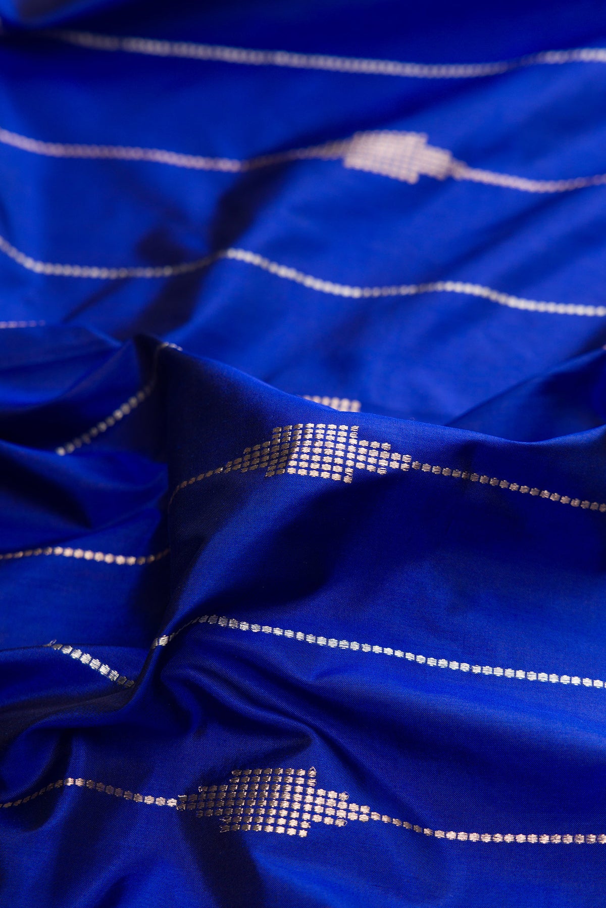 Close up of Pure Silk Royal Blue Dual Tone Banarasi Saree with Stripes on the body and Zari Border.  displaying folds