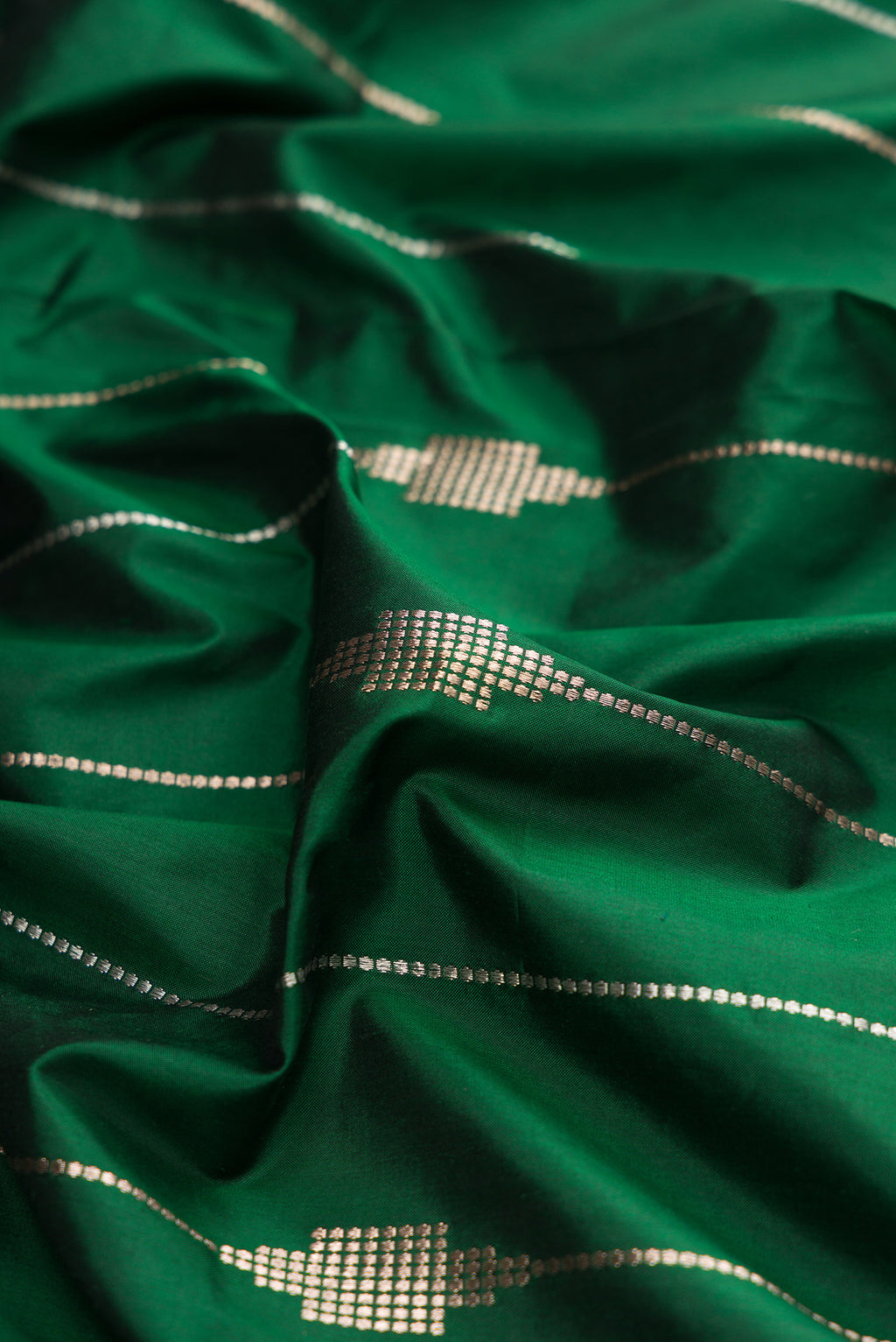 Close up of Pure Silk Green Dual Tone Banarasi Saree with Stripes on the body and Zari Border.  displaying folds