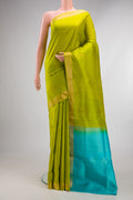 Pure Silk Parrot Green Soft Saree with Zari Butta on the body and Zari Border.  displayed on a mannequin