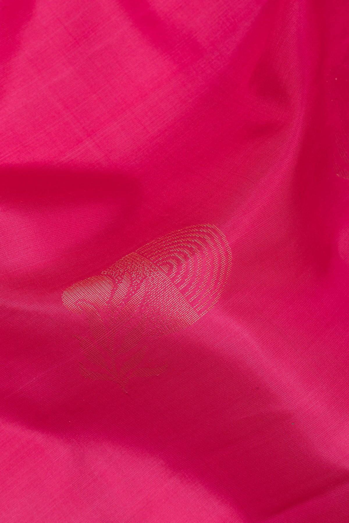 Close up of Pure Silk Pink Soft Saree with Zari Butta on the body and Zari Border.  displaying folds