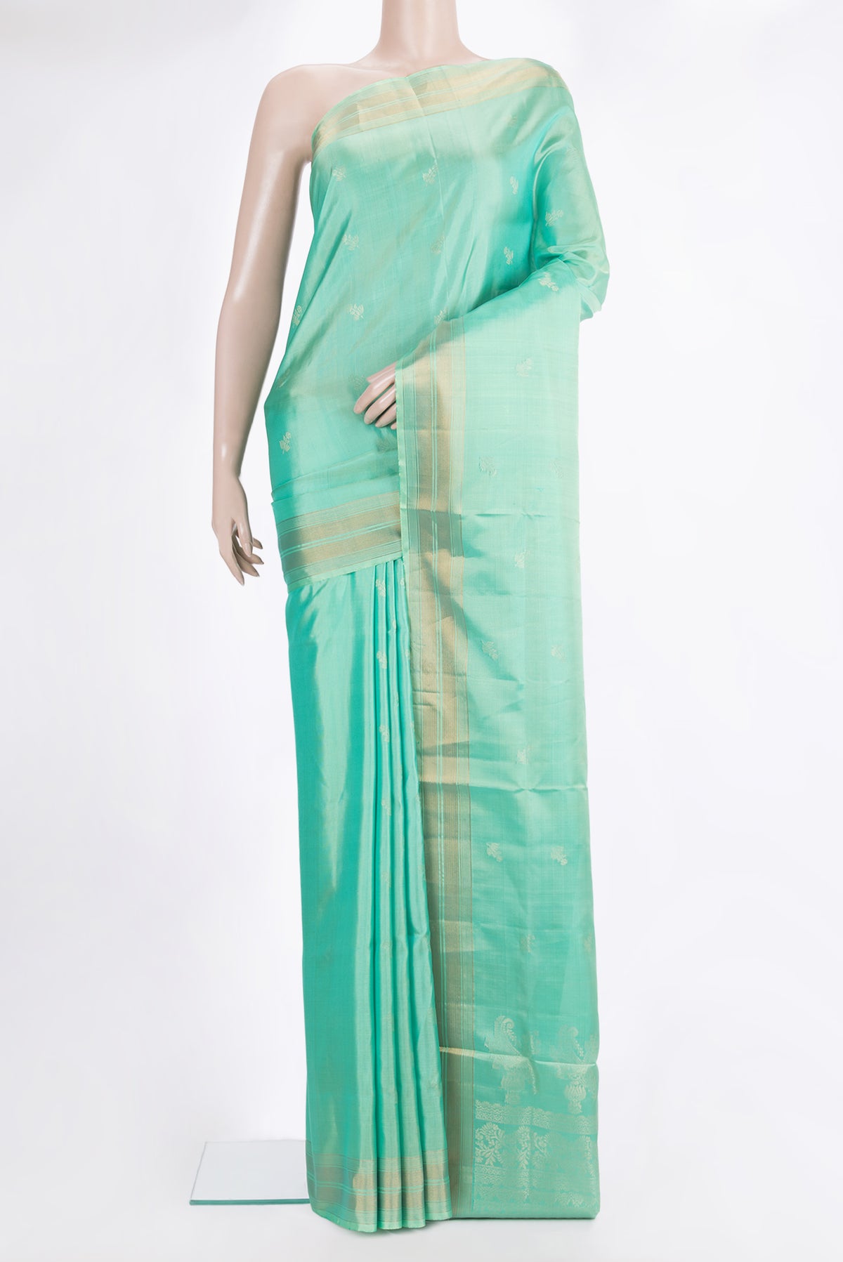 Pure Silk Sea Green Soft Saree with Zari Butta on the body and Zari Border.  displayed on a mannequin