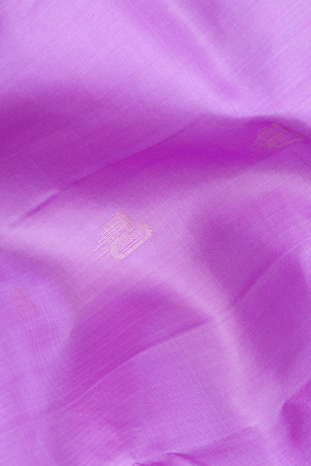 Close up of Pure Silk Lavender Soft Saree with Zari Butta on the body and Zari Border.  displaying folds